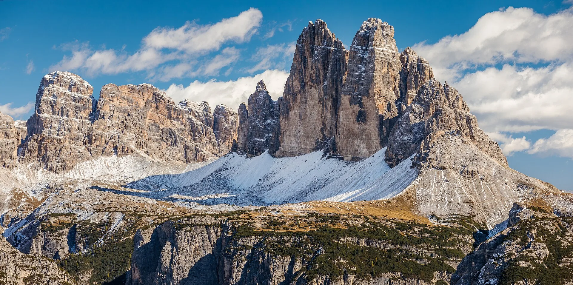 The three peaks of the Tre Cime di Lavaredo rising against a blue sky in the Dolomites, Italy